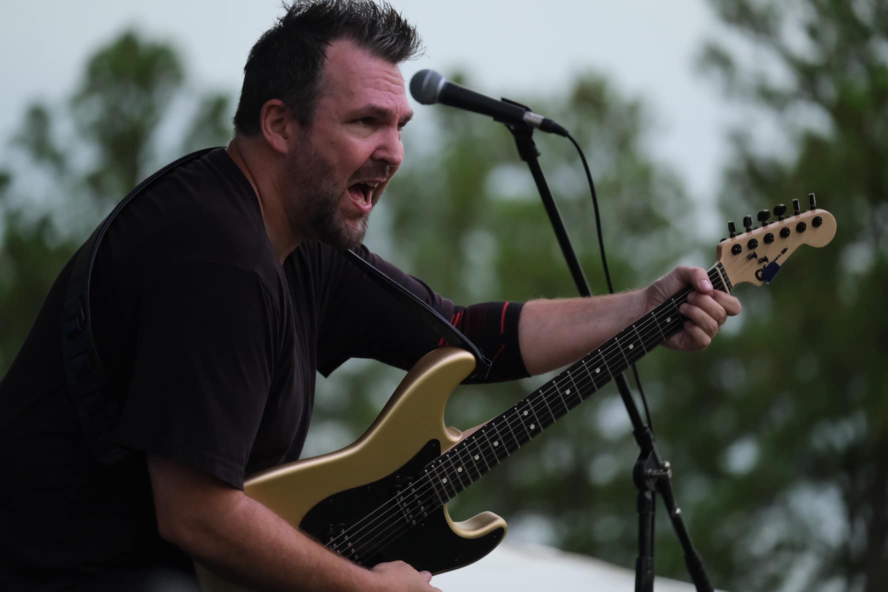 Billy Parvin singing on outdoor stage